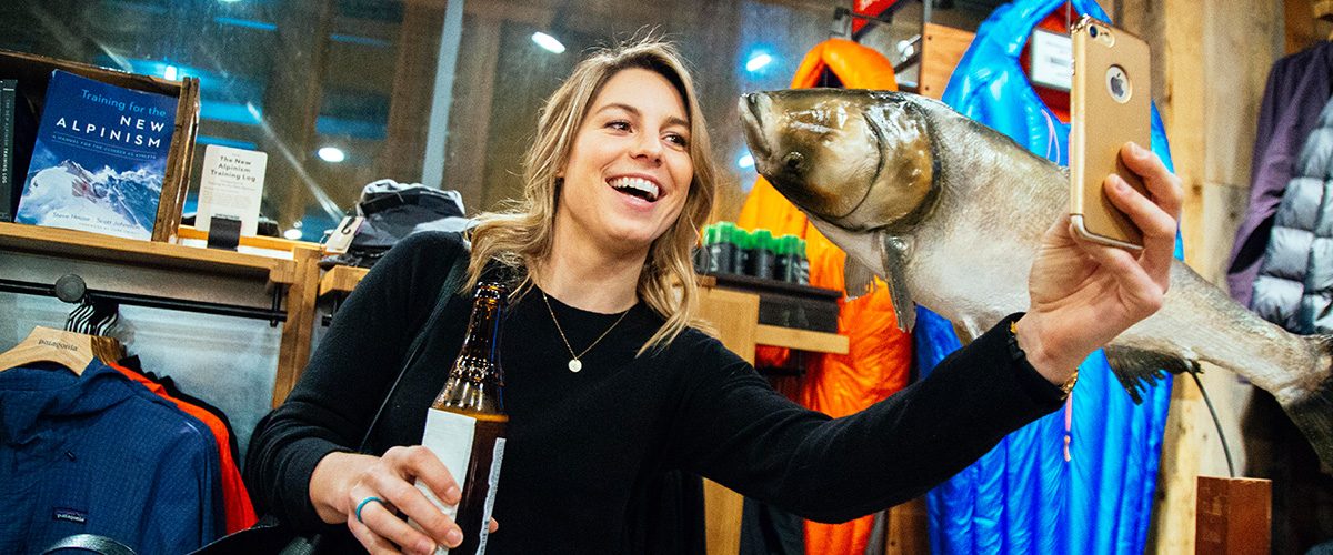 Guests takes a selfie photo with a taxidermied Asian Carp.