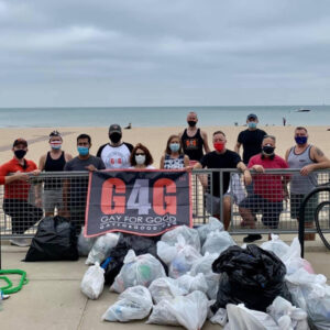 Adopt-a-Beach volunteers pose with trash they removed